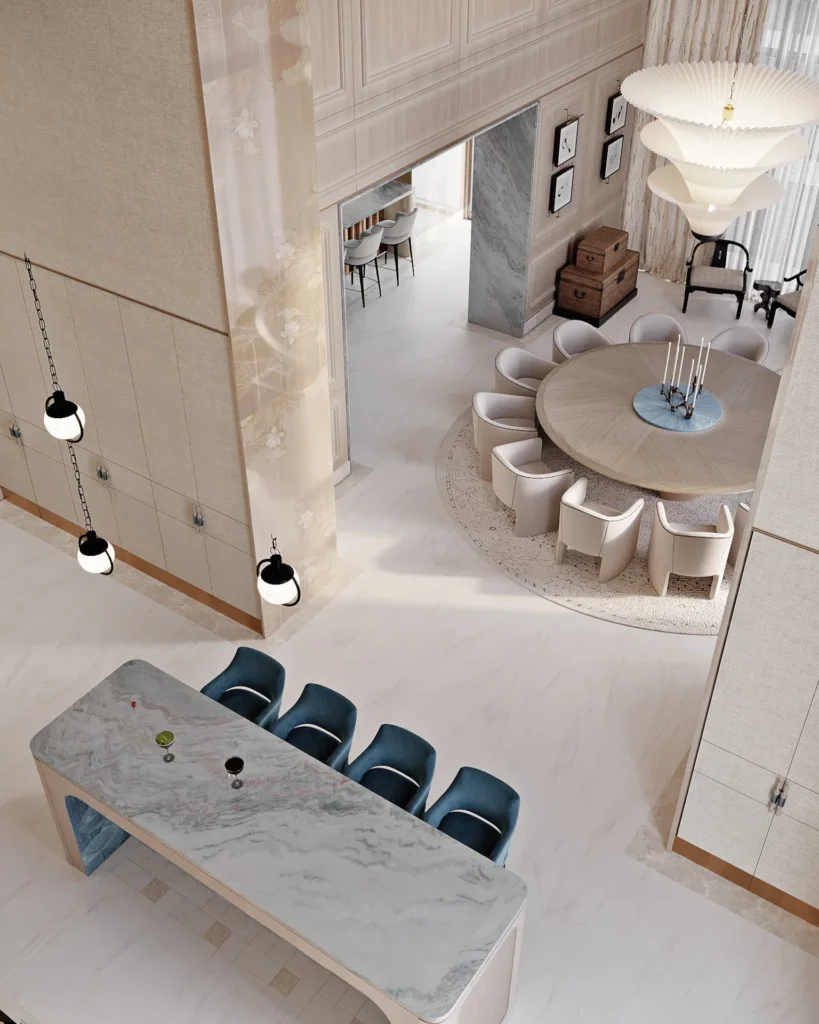 Formal dining: round table for 8‑10 guests, cream upholstered chairs, a white pleated multi‑tier chandelier, coffered ceiling with blue wave‑pattern wallpaper, and a decorative blue screen.