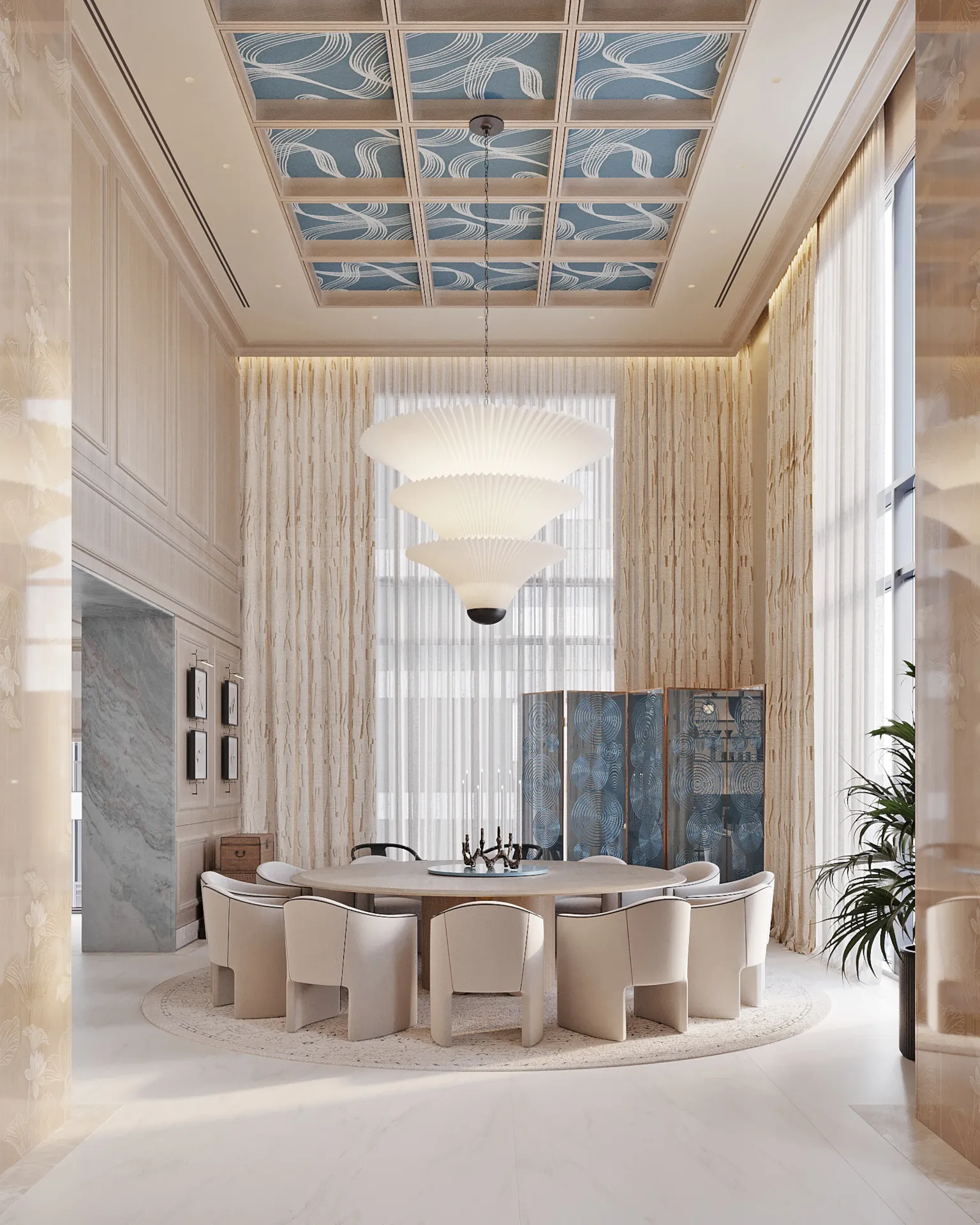 Formal dining: round table for 8‑10 guests, cream upholstered chairs, a white pleated multi‑tier chandelier, coffered ceiling with blue wave‑pattern wallpaper, and a decorative blue screen.